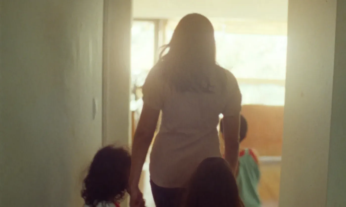 A mother and her children together at home