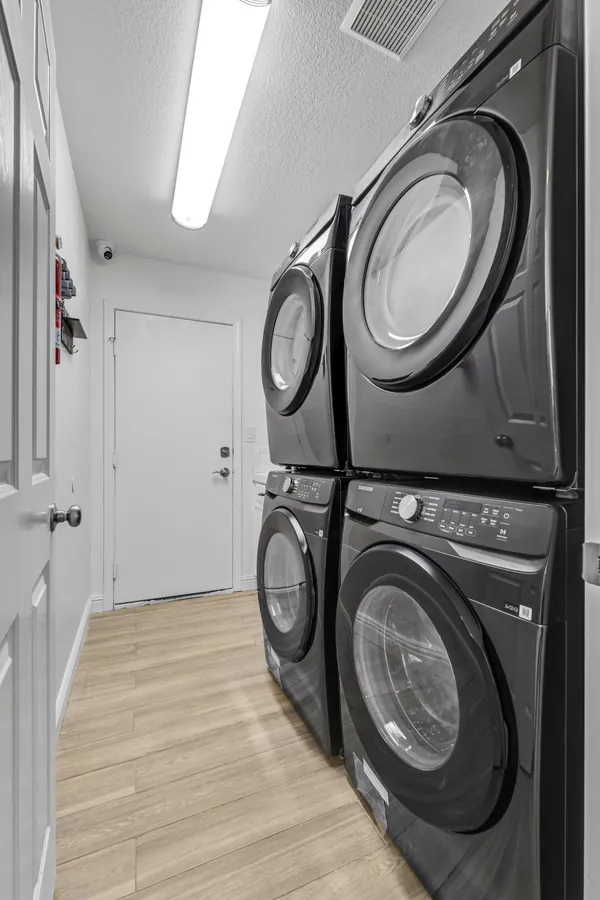 Laundry room with stacked washers and dryers